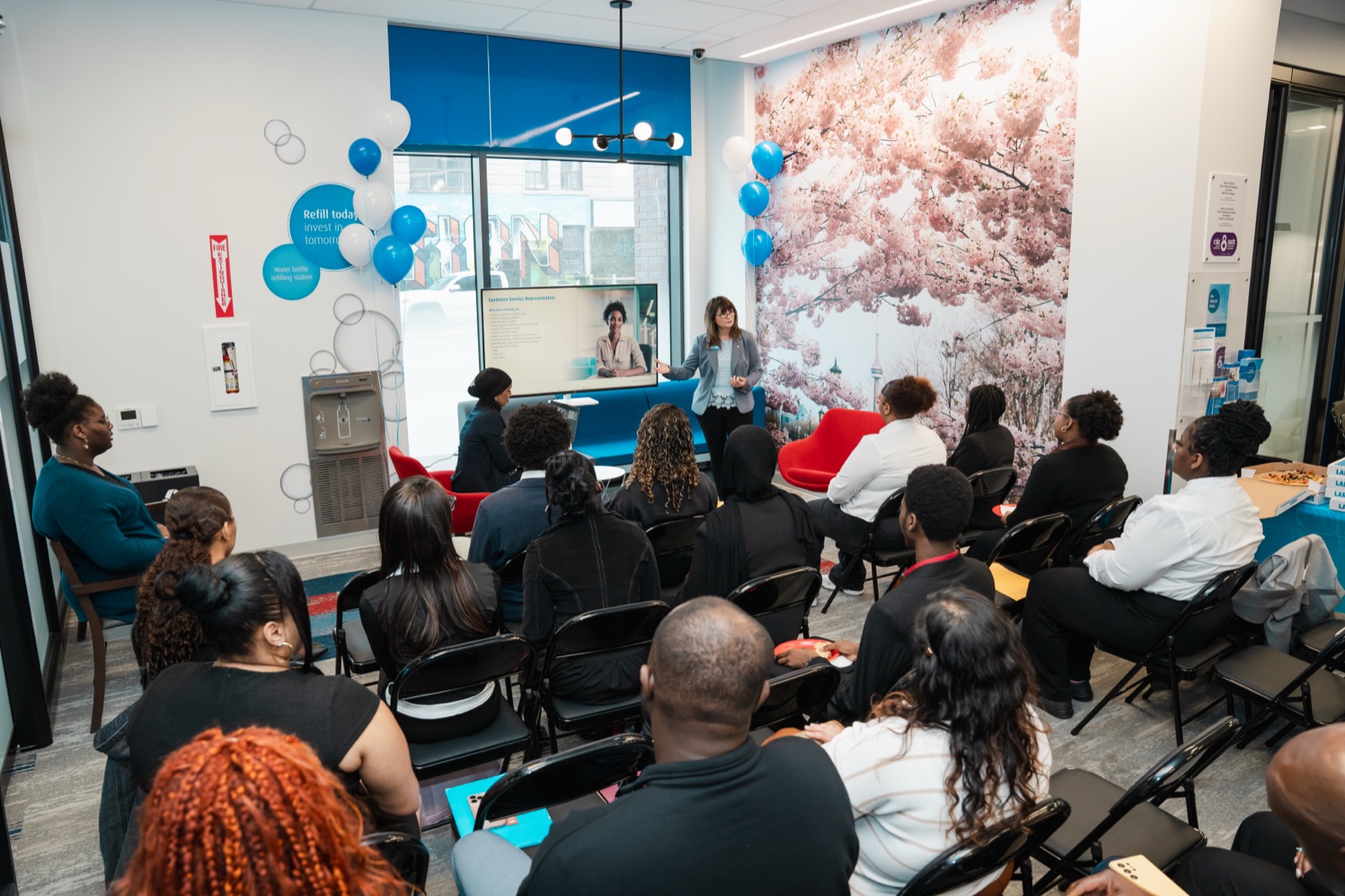 A recruiting leader from a major Canadian bank presenting to a cohort of youth at a Facilitate hiring and financial-literacy activation